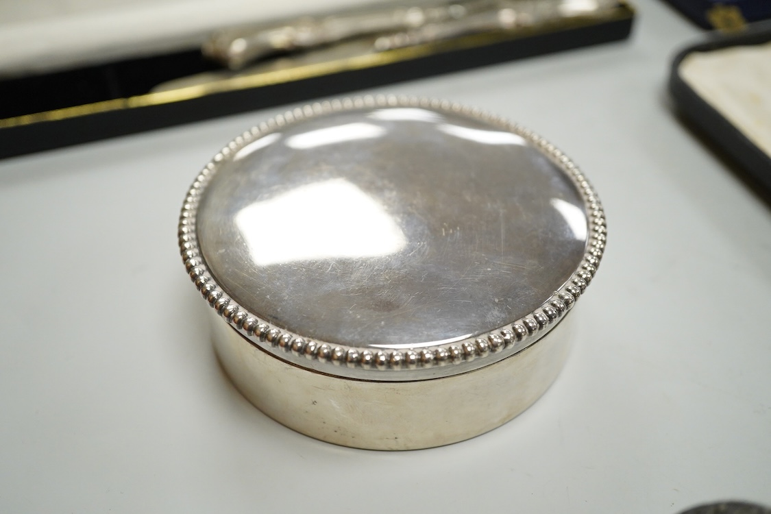 A Portuguese white metal 916 standard circular box and cover, retailed by Joalharia Do Carmo, diameter 94mm, together with cased set of six silver plated coffee spoons, a cased silver teaspoons, a Victorian silver christ